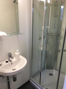 a bathroom with a sink and a shower at Guesthouse- Møllegata 39 in Stavanger