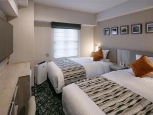 Postel nebo postele na pokoji v ubytování Hotel Mystays Kagoshima Tenmonkan Annex + 19 fotografií