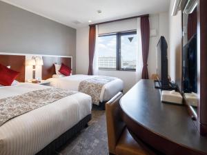 Postel nebo postele na pokoji v ubytování HOTEL MYSTAYS Maihama