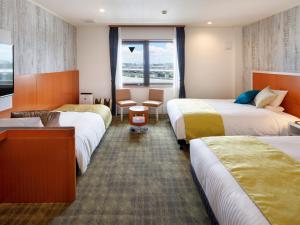 Postel nebo postele na pokoji v ubytování HOTEL MYSTAYS Maihama