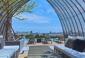 a view from the roof of a building with chairs at Chezzotel Pattaya in Pattaya