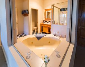 a bathroom with a sink and a bath tub at Strathearn Park Lodge in Scone