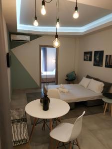 a room with a bed and a table and chairs at City Center Studios in Kavála +28 photos