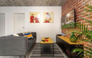 a living room with a couch and a brick wall at Orion apartment in Poreč