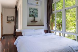 Postel nebo postele na pokoji v ubytování Photharam126 Resort