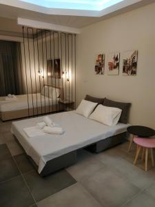 a bedroom with a bed with two towels on it at City Center Studios in Kavála