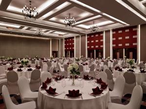 a large banquet hall with white tables and chairs at Pullman Hanoi in Hanoi +150 photos