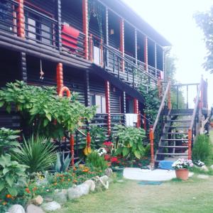 a building with stairs and flowers in front of it at BLACK-HOUSE in Pizunda