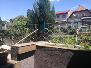 a balcony with a garden with a fence at CoquetteHouse Cotroceni Palace in Bucharest