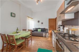 eine Küche und ein Wohnzimmer mit einem Tisch und einem Sofa in der Unterkunft Apartment San in Ližnjan