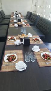 a long table with plates of food on it at Bely Parus in Bosteri