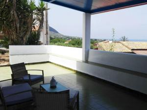 a patio with chairs and a table on a balcony at Belvedere Tramontana in Ustica