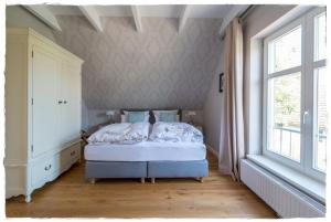 En eller flere senger på et rom på Ferienhaus Malve in Liepe