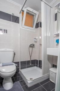 a bathroom with a shower and a toilet and a sink at Melissi in Lefkada Town