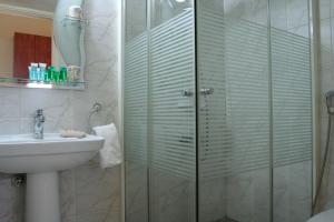 a bathroom with a shower and a sink at Byblos Comfort Hotel in Jbeil