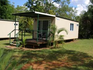 a tiny house with a porch and a deck at Pandanus on Litchfield in Batchelor