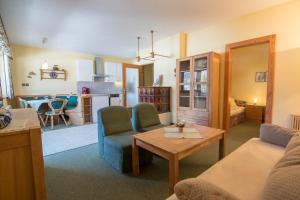 a living room with a couch and a table at Appartementhaus Turracher Höhe in Turracher Hohe