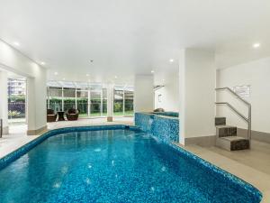 an indoor swimming pool with blue water in a house at Sunbird Beach Resort in Gold Coast