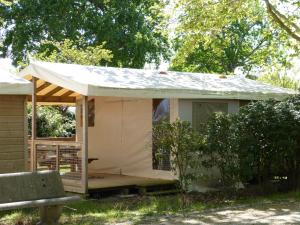 a small house with a tarp on it at Camping Routes du Monde ATC La Hume-Arcachon in Gujan-Mestras
