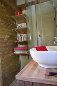 a bathroom with a white sink on a wooden counter at Camping Routes du Monde ATC La Hume-Arcachon in Gujan-Mestras