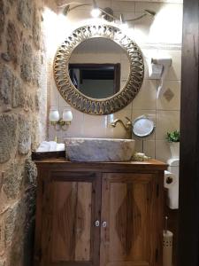 a bathroom with a sink and a mirror on the wall at George & Alexandra's Apartments in Rhodes Town