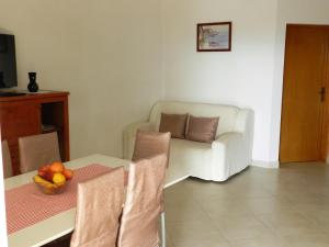 un soggiorno con divano e tavolo con cesto di frutta di Apartmani Lucija Jurković a Malinska