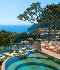 einen Pool mit Stühlen und Meerblick in der Unterkunft Casa Morgano in Capri