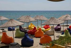 a group of colorful chairs and umbrellas on a beach at Silivri Park Hotel in Silivri