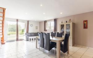 a dining room with a table and chairs at Les Champs De La Mer in Auberville-la-Renault