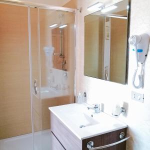 a bathroom with a sink and a shower at PARADISO Hotel Ristorante in Reggio Calabria
