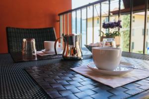a table with two cups and aucer on top of a table at Valle dei Mulini - Lake Como in Bellano