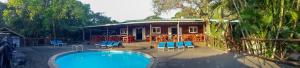 a house with a swimming pool in front of it at Coral Divers in Sodwana Bay