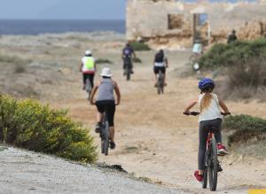 un grupo de personas montando bicicletas por un camino de tierra en Dar Gitta & Wood El Haouaria en El Haouaria