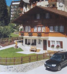 a car parked in front of a house at Chalet Waldperle in Arosa