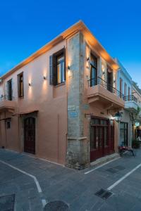 a building with a balcony on the side of it at Casa Di Silvia in Rethymno Town
