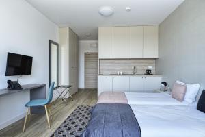 a hotel room with a bed and a kitchen at Arche Hotel Poloneza in Warsaw