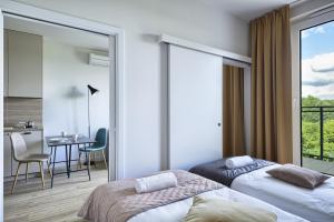 Łóżko lub łóżka w pokoju w obiekcie Arche Hotel Poloneza