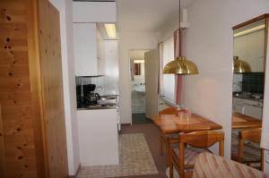 a small kitchen with a table and a dining room at Paradies 503 in Arosa