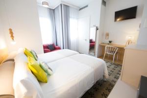 Posteľ alebo postele v izbe v ubytovaní Hotel Catalina