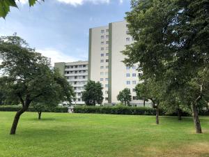 duży biały budynek z drzewami w parku w obiekcie City Apartments Klinikum w mieście Klagenfurt