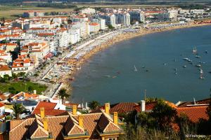 a city with a beach and boats in the water at São Martinho do Porto Beach Apartment in São Martinho do Porto