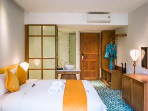 a bedroom with a large bed and a bathroom at Vinh Hung Old Town Hotel in Hoi An