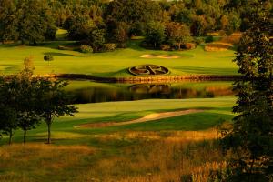 a view of a golf course with a pond at Slieve Russell Hotel in Ballyconnell