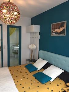 a bedroom with a bed with a blue wall at Le Domaine de Charline de 1 à 35 personnes in Issel +81 photos