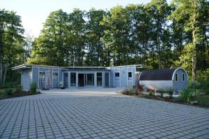 a house with a driveway in front of it at Bienenhaus in Sassnitz