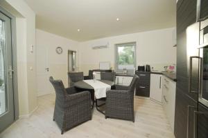 a kitchen with a table and chairs in a room at Bienenhaus in Sassnitz