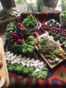 a bunch of vegetables on cutting boards on a table at Guest House Gzirishvili in Kvareli