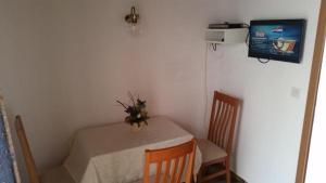 a small table and chairs in a small room at Small apartment Merica in Novalja