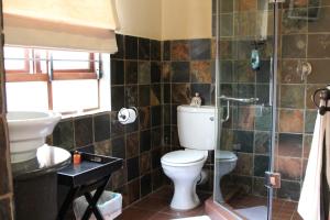 a bathroom with a toilet and a sink at Micasa Sucasa Guesthouse in Lephalale +48 photos