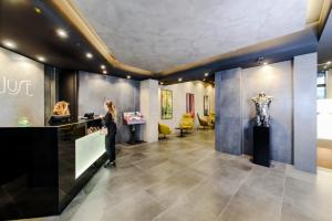 a woman standing in front of a exhibit in a museum at Just Hotel Milano in Milan